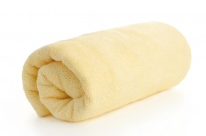 rolled up yellow beach towel