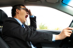 Exhausted driver yawning and driving  car