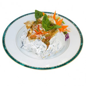 thai steamed fish curry custard in Tin foil (Hormok) isolated on