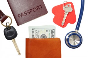 Car key, house key, passport and stethoscope with money in wallet