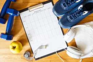 Personal workout plan with sneakers and dumbbells