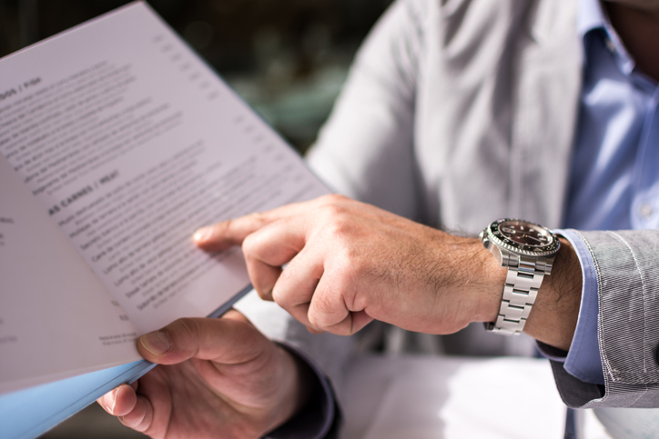 Male Hand Holding Restaurant Menu to Make Order for Lunch